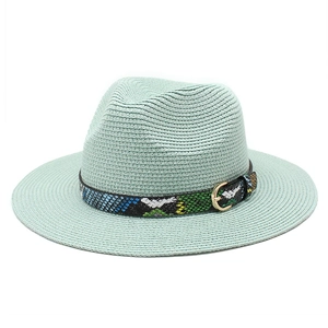 Detail of mint green fedora straw hat with snake print leather band and golden buckle