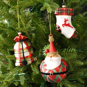 Set of 3 painted glass Christmas ornaments featuring Santa, a gift bag, and a stocking