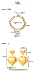 Detailed view of gold heart jewelry set with Cuban chain bracelet and dangling earrings