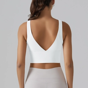 Detail of white V-back sports bra featuring wide straps and moisture-wicking fabric texture