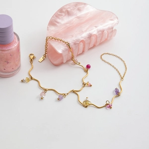 Detail of 18k gold wave chain with colorful natural stones and pearls for women