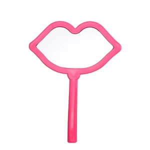 Lip-shaped pink handheld makeup mirror with ergonomic handle on a white background