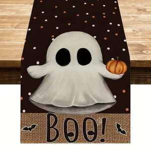 Detail of Halloween ghost and pumpkin pattern with BOO lettering on linen table runner