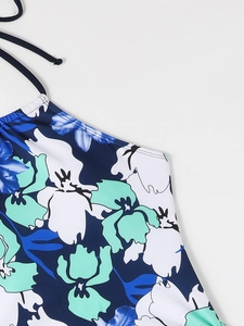 Detail of floral halter bikini top with blue and mint abstract pattern and ties
