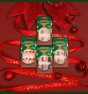 Close-up of Christmas press-on nails set with festive reindeer and snowflake patterns