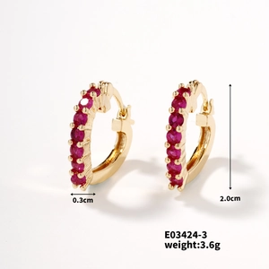 Detail view of heart-shaped gold hoop earrings with red stone inlay and dimensions