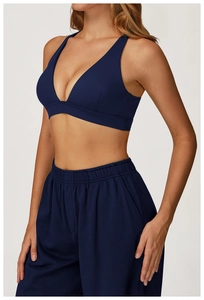 Detail of navy blue sports bra with V-neck cut and high-quality knit fabric texture