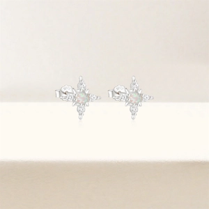Detail of S925 sterling silver sunburst stud earrings with white opal and clear zircons