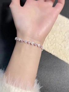 Detail of pink and white flower bracelet with sparkling cubic zirconia on a wrist