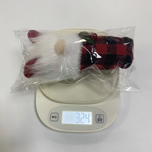 Detailed view of weighted Christmas gnome plush ornament showing 32.4g on a digital scale