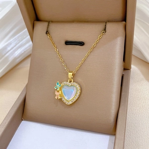 Macro shot of iridescent heart pendant with pavé crystals and colorful butterflies