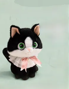 Close-up of black and white plush cat toy with a white lace collar and pink silk bow