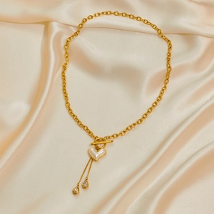 Gold necklace with heart pearl pendant and crystal tassels on champagne silk