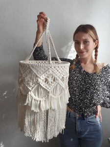 Detail of bohemian handmade macrame lampshade with tassel accents and woven patterns