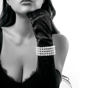 Detail of four-layer white pearl beaded bracelet on elegant black silk gloves