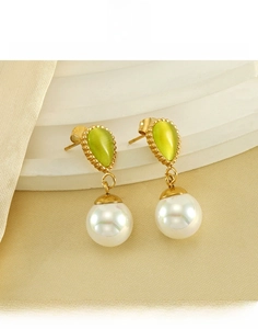 Detail of teardrop cat-eye stone and pearl earrings made of durable titanium steel