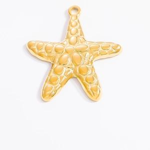 Macro detail of 18k gold starfish pendant with natural texture and hanging loop