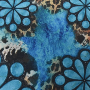 Macro detail of bohemian floral and leopard print fabric textures on the baseball cap