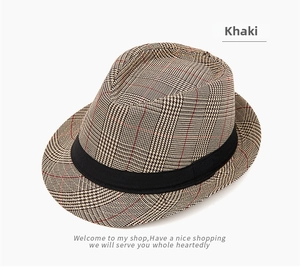 Top-down view of khaki plaid fedora hat with classic black ribbon trim and fine texture