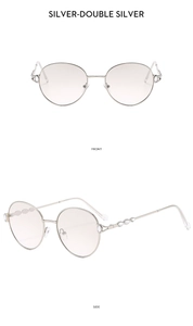 Front and side views of silver round metal frame sunglasses with diamond accents