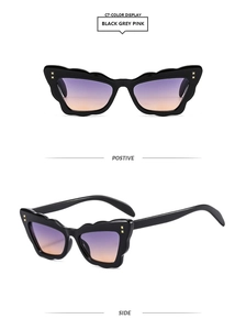 Detailed view of cat eye sunglasses with wavy frames and purple gradient lenses