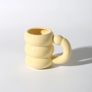 Cute creamy yellow ceramic mug with a unique three-tier stacked bulbous ring design