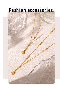 Detail of gold titanium star pendant necklace with crystal and hollow link chain
