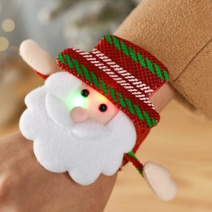 Close-up of glowing LED Santa Claus slap bracelet with red sequins and soft plush material