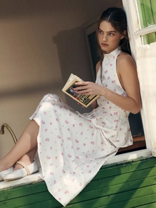 Detail of white floral print satin set featuring halter neck and bubble hem design