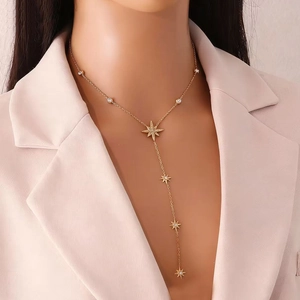 Elegant gold Y-shaped necklace with eight-pointed star pendants and clear cubic zirconia