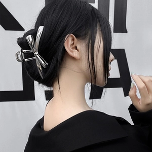 Silver Y2K metal butterfly hair claw clip worn by model for elegant hairstyling