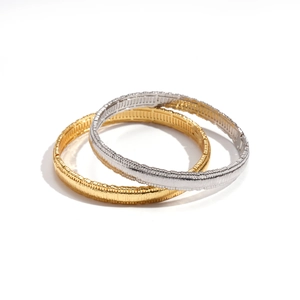 Set of gold and silver geometric round bracelets with vertical textured striped design