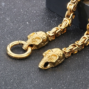 Close-up of golden punk skull charm on a vintage Byzantine chain for men