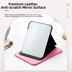 Detail of portable folding makeup mirror with textured PU leather stand in pink and black