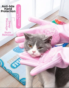 Pink silicone pet grooming glove massaging a cat during bath for hair removal