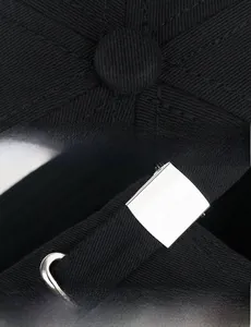Detail view of cotton baseball cap with adjustable metal slider and premium stitching