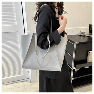 Fashionable grey large capacity tote bag shown on model for a minimalist commuting style