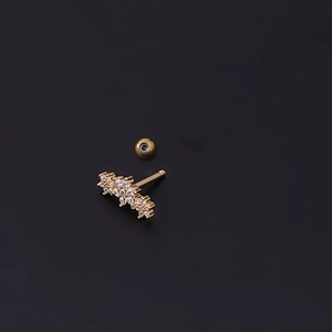 Macro detail of golden leaf earring with sparkling zircons and screw-on ball back