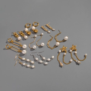 Detail of baroque freshwater pearl and gold tassel earrings with shell and starfish motifs