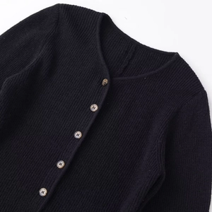 Women's black rib-knit long sleeve cardigan with amber texture buttons and round neck