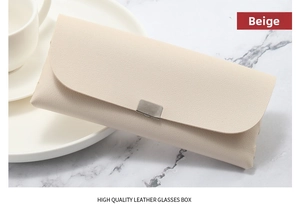 Close-up of beige lychee texture leather glasses case with metallic silver buckle