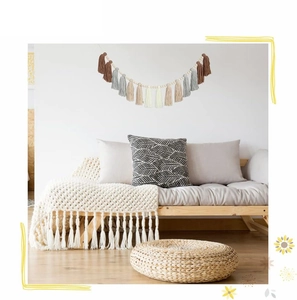 Detail of bohemian tassel garland with wooden beads on wall in a cozy living room decor