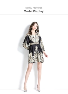 Detail of V-neck paisley print mini dress with lantern sleeves and belted waist in black