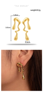 Detailed view of gold irregular liquid metal earrings with measurements 3.83cm by 1.28cm