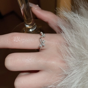 Detail of zircon butterfly open ring showing intricate stone setting on adjustable band