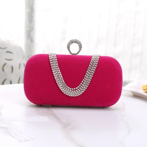 Close-up of pink velvet evening bag with U-shaped crystal fringe and round diamond clasp
