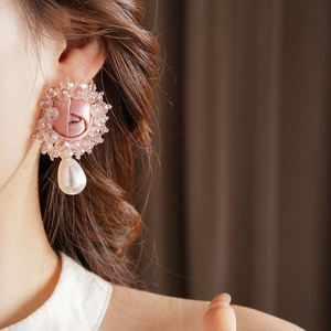 Detail of pink satin rose earrings with beaded border and white teardrop pearl pendant
