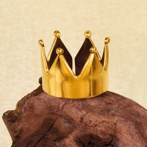 Minimalist 18k gold crown ring with adjustable open band on a wooden display