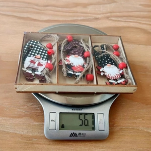 Three-piece wooden Christmas gnome ornaments set weighing 56.1g in a wooden tray