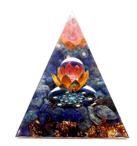 Macro detail of Orgone pyramid with blue crystals, gold lotus, and crystal ball